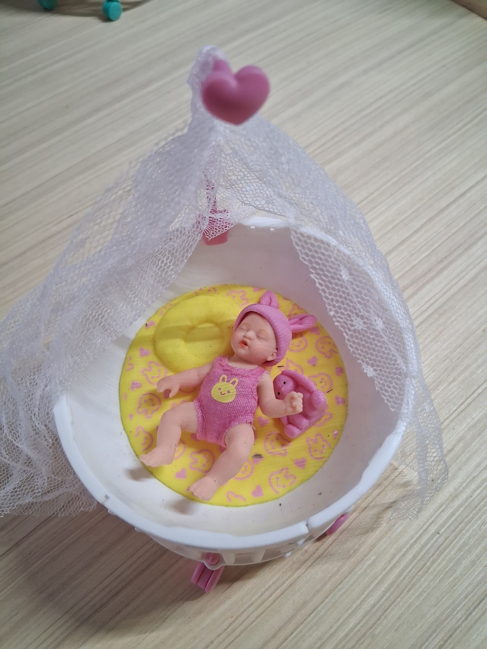 Mini Baby Doll in Pink Outfit with Yellow Bedding